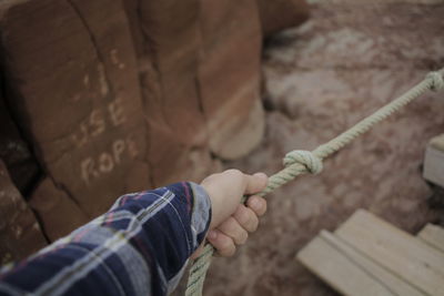 High angle view of man holding rope