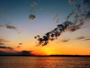 Scenic view of sea against romantic sky at sunset