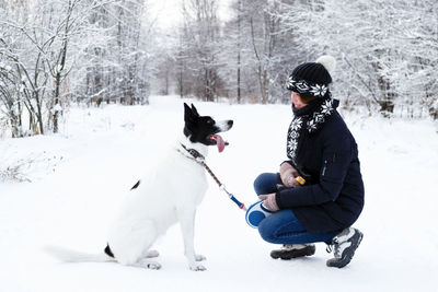 Woman with dog in snow