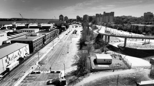 High angle view of vehicles on road along buildings
