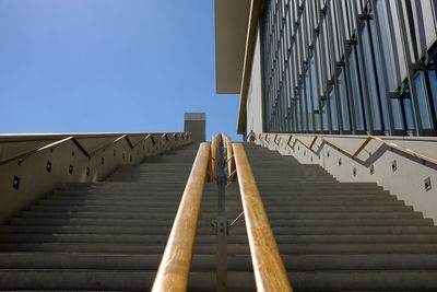 Low angle view of stairs against clear blue sky