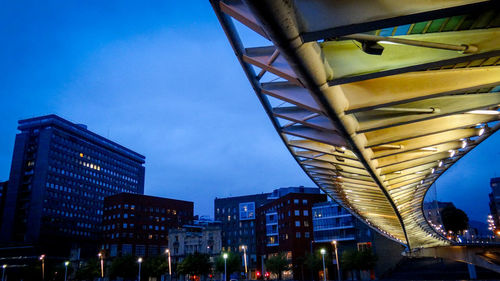 Low angle view of illuminated buildings against sky at night