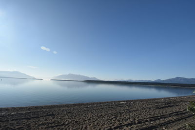 Scenic view of lake against clear blue sky