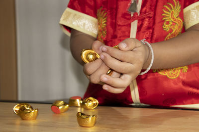 Midsection of woman holding candles