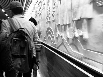 Rear view of man standing on train window