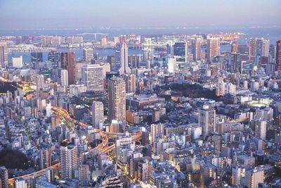 High angle view of modern buildings in city against sky