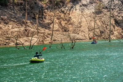 People kayaking in sea