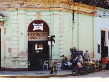 People on street against building in city