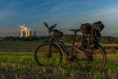 Bicycle on field against sky