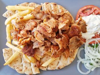 Close-up of gyro with potato chips on table