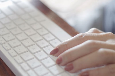Cropped hands using laptop