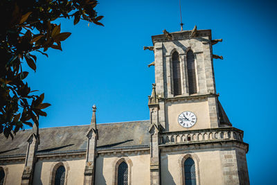 Low angle view of historic building against clear blue sky