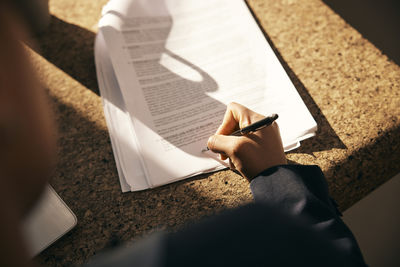 Low section of woman reading book