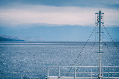 Mast of a ferry on the mediterranean sea with islands and mountains ahead