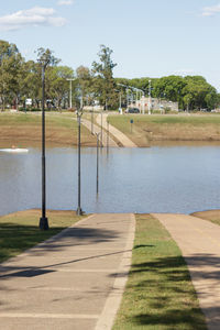 Road by lake against sky