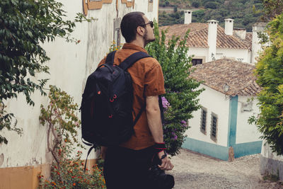 Rear view of man and woman standing against building