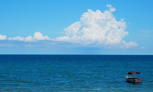 Boats in sea against sky