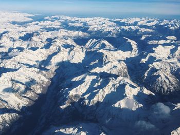 Aerial view of snowcapped mountain against sky