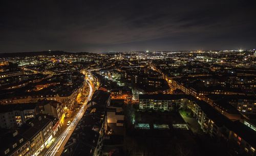 Aerial view of illuminated cityscape against sky at night