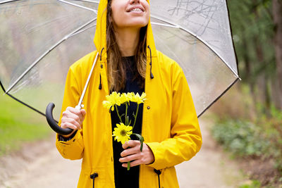 Portrait of young woman holding umbrella