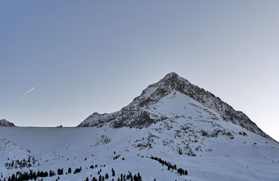 Scenic view of snowcapped mountains against clear sky