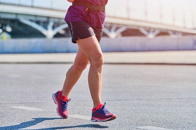 Running woman. fitness woman jogging in sportswear on city road. street workout, fitness outdoor