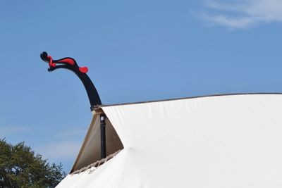 Low angle view of red umbrella against clear sky