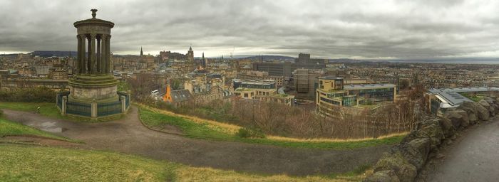 View of cityscape against cloudy sky