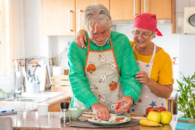 Full length of a woman preparing food at home