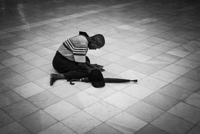 Man sitting on tiled floor