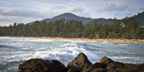 Scenic view of sea and mountains against sky