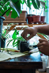 Painting a recycled flower pot in black at home. diy makeover indoor plants project.