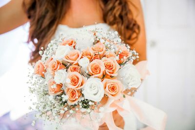 Close-up of woman with red roses