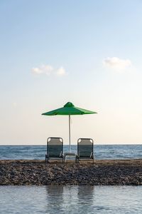 Lifeguard hut on beach against sky