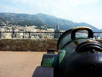 Close-up of fort against sea and cityscape