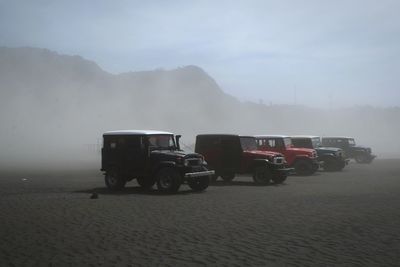 Vintage car on foggy weather against sky