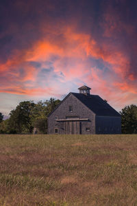 Sunset over a rustic barn in a field on cape cod, massachusetts