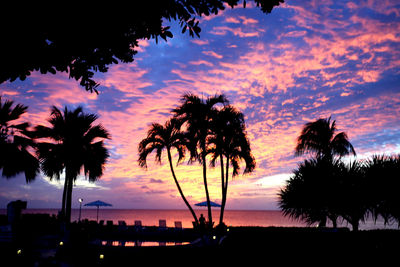 Silhouette palm trees against sky during sunset