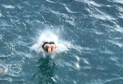 High angle view of young woman swimming in pool