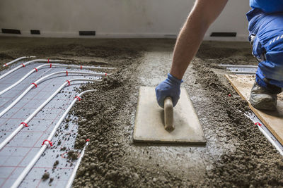 Low section of man working on concrete