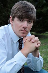 Portrait of young man sitting outdoors