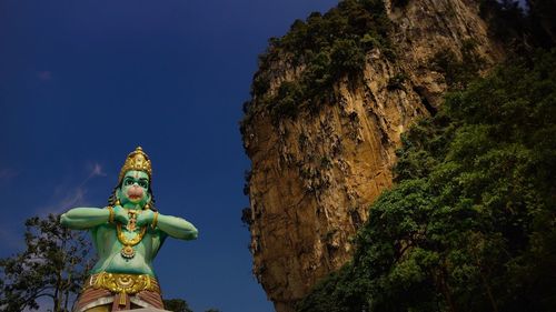 Low angle view of hanuman statue against sky