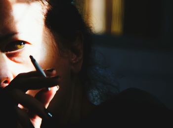 Close-up of woman holding cigarette