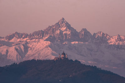 Scenic view of snowcapped mountains against sky during sunset