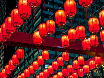 Low angle view of illuminated lanterns hanging at night