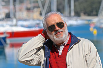 Mature man wearing sunglasses at harbor