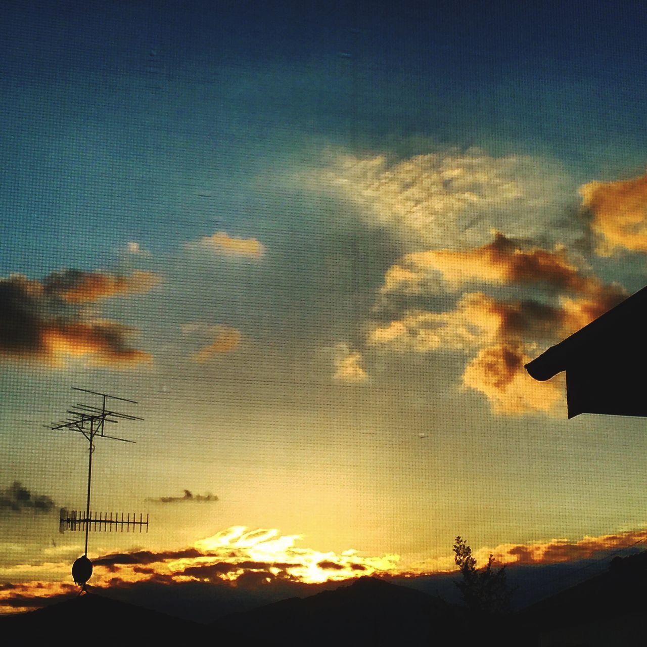 sunset, silhouette, sky, cloud - sky, orange color, building exterior, built structure, dramatic sky, architecture, low angle view, beauty in nature, cloud, scenics, dusk, sun, nature, landscape, outdoors, house, cloudy