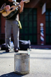 Low section of man standing on street in city