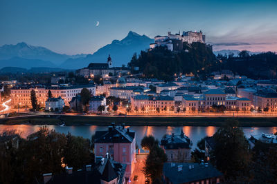 High angle view of illuminated town during dusk