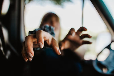 Woman gesturing in car